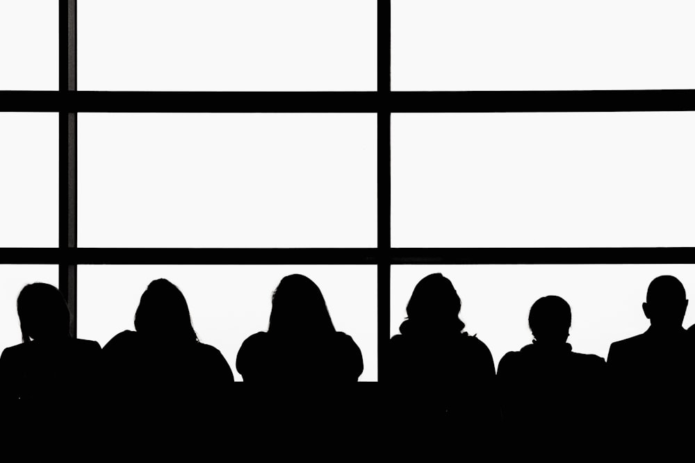 silhouette of people sitting on chair