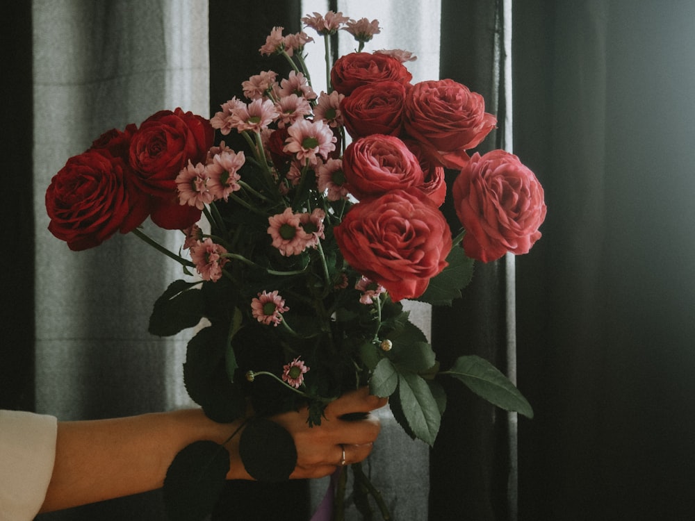 red roses in brown vase