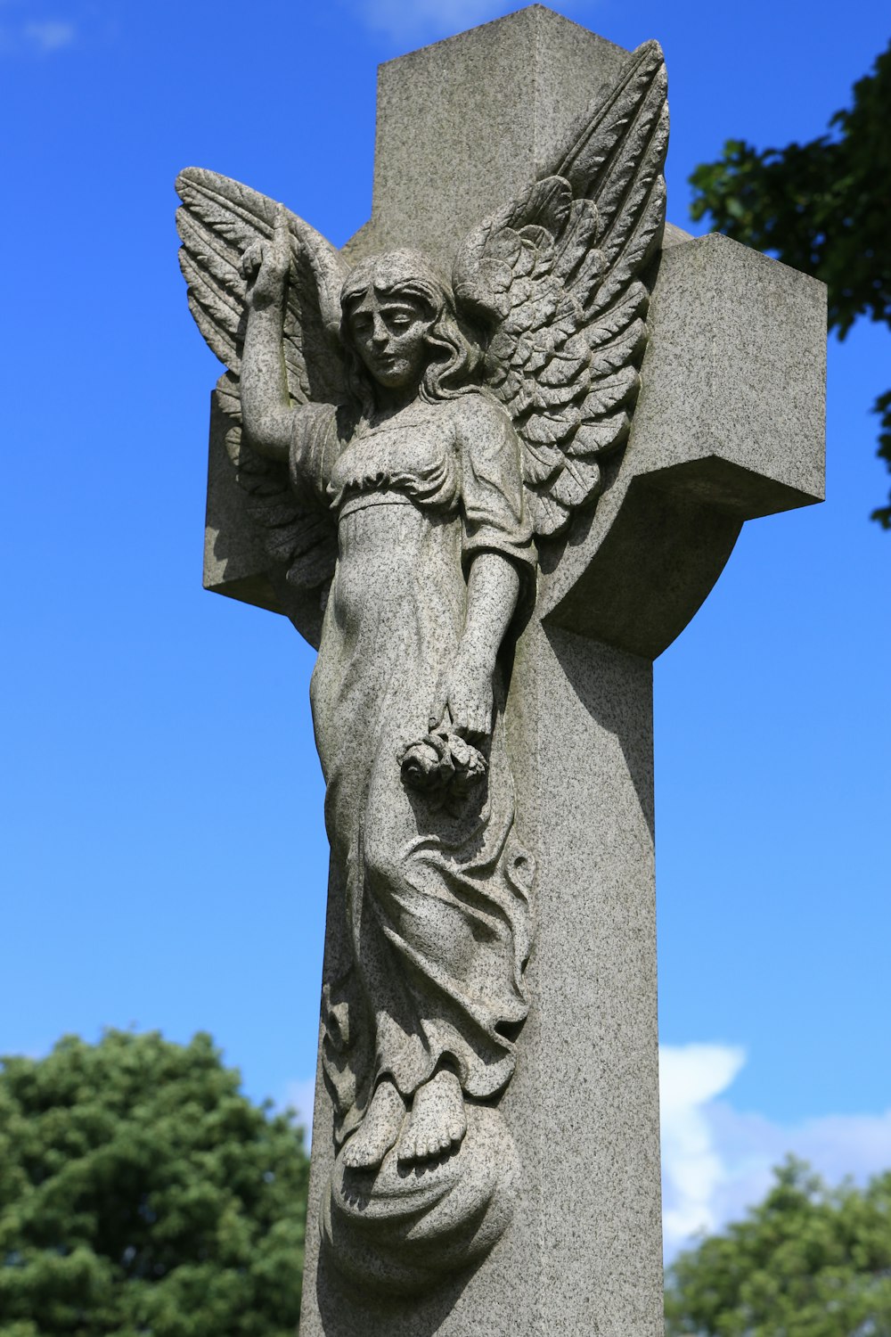 gray concrete angel statue during daytime