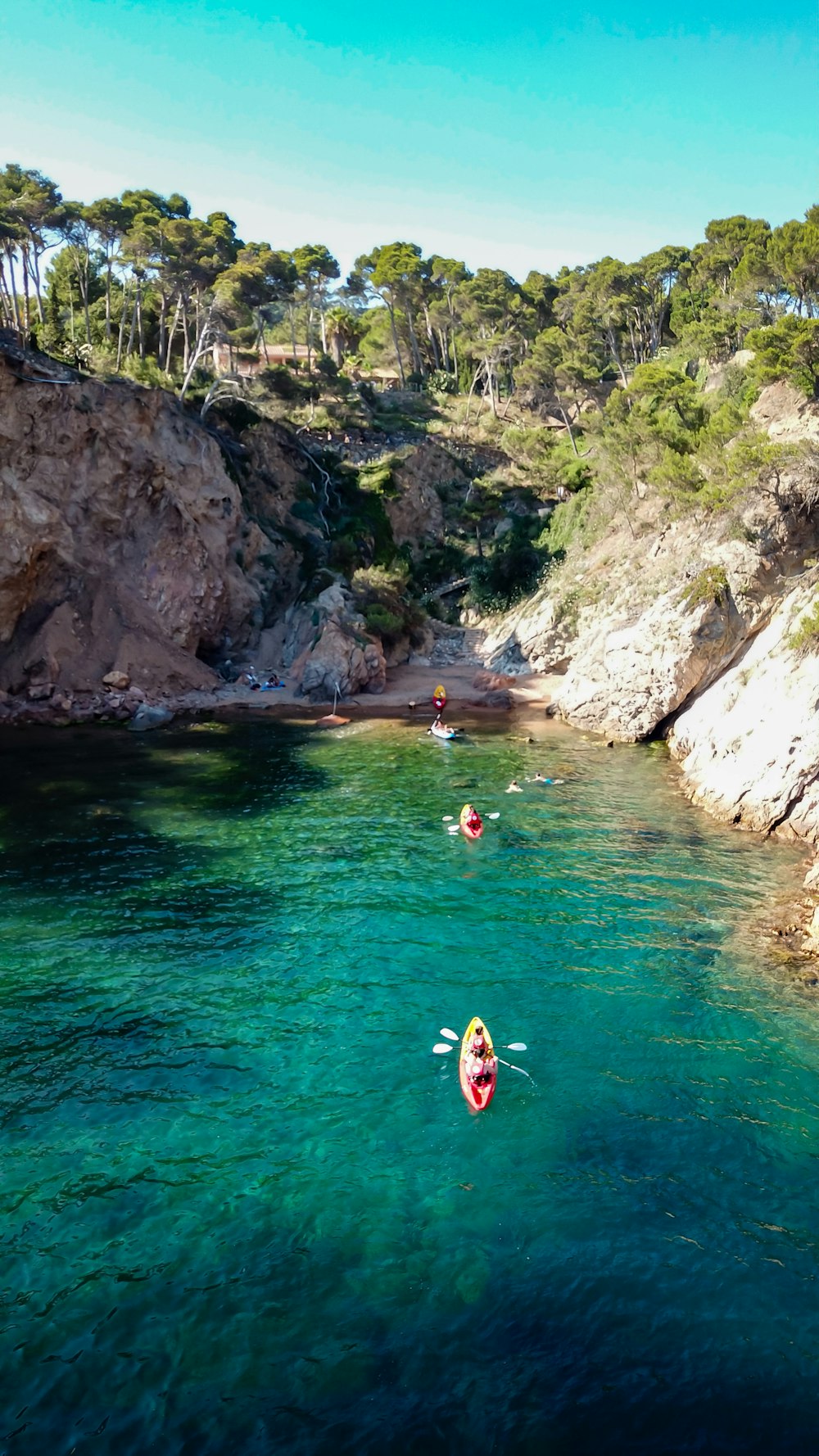 people in red kayak on river during daytime