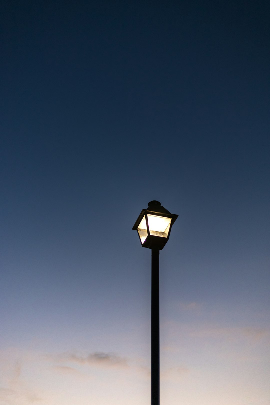 black street lamp under blue sky during daytime