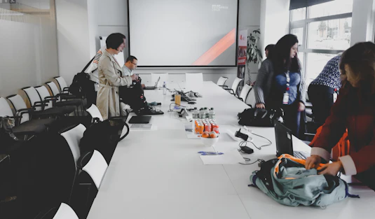 man in white dress shirt sitting on black office rolling chair