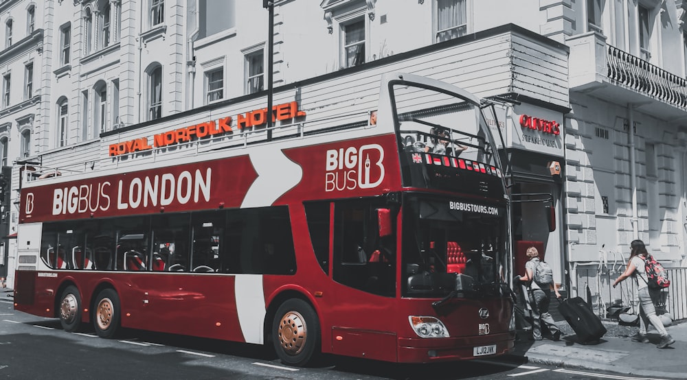 red and black double decker bus on road during daytime