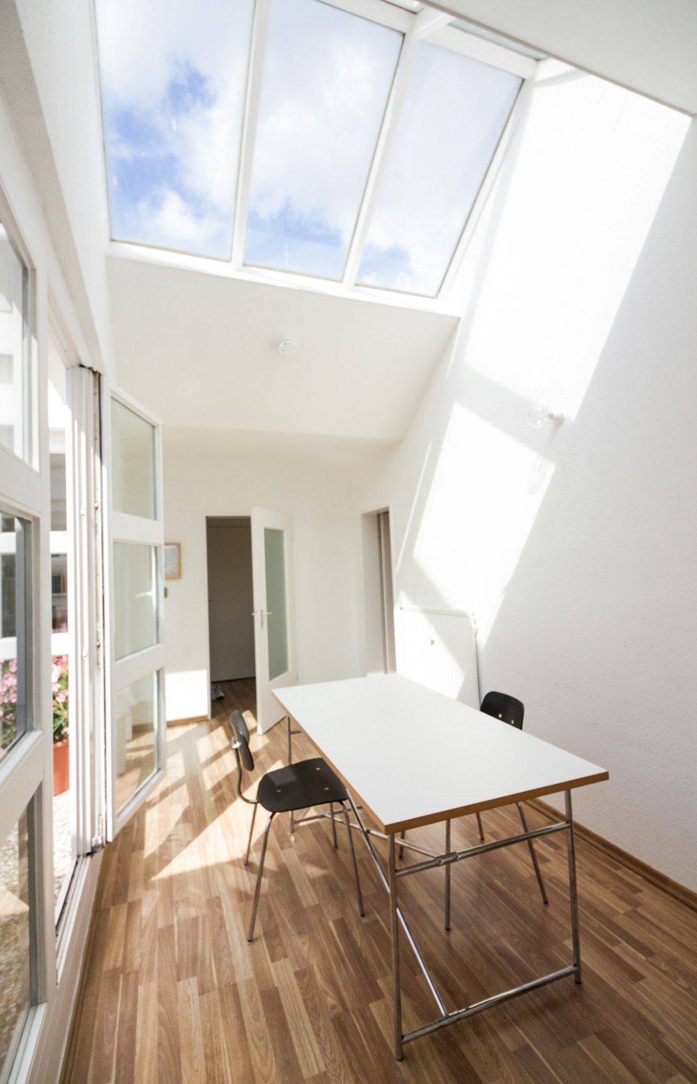 white wooden table near white wall