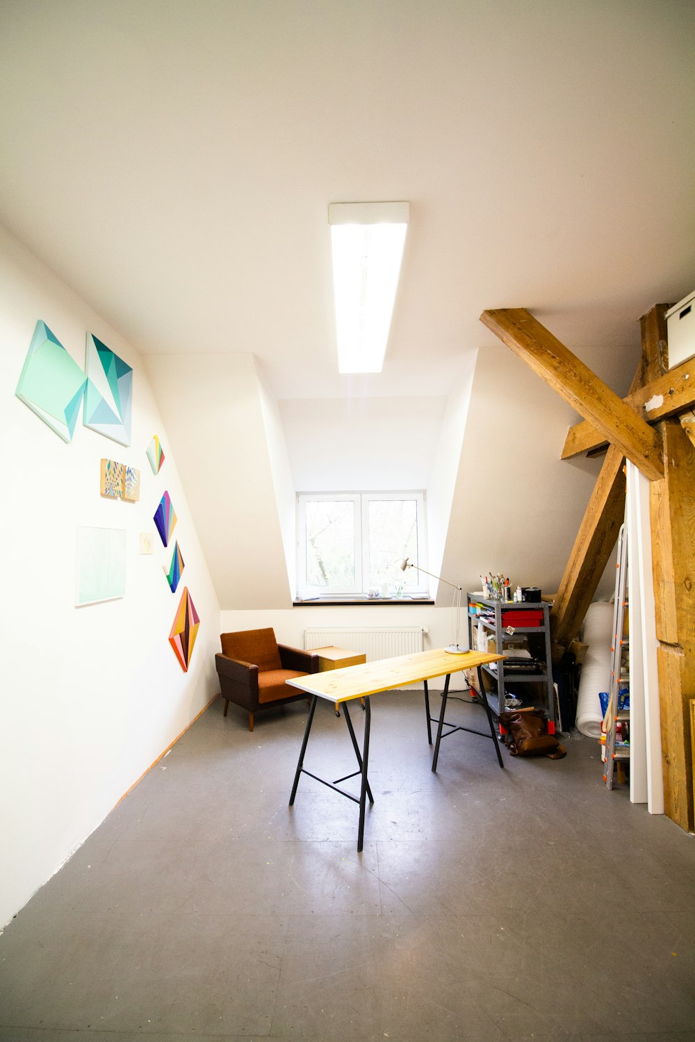 brown wooden table near white wall