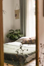 Cozy bedroom with green accents and soft lighting.