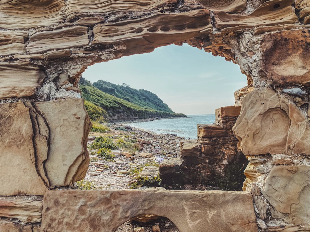 brown rock formation near body of water during daytime