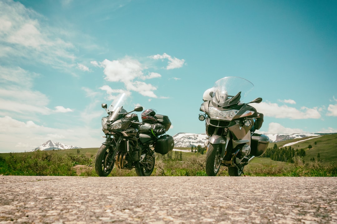 2 motorcycle parked on dirt road during daytime