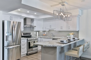 Sleek kitchen featuring stainless steel appliances and granite countertops.