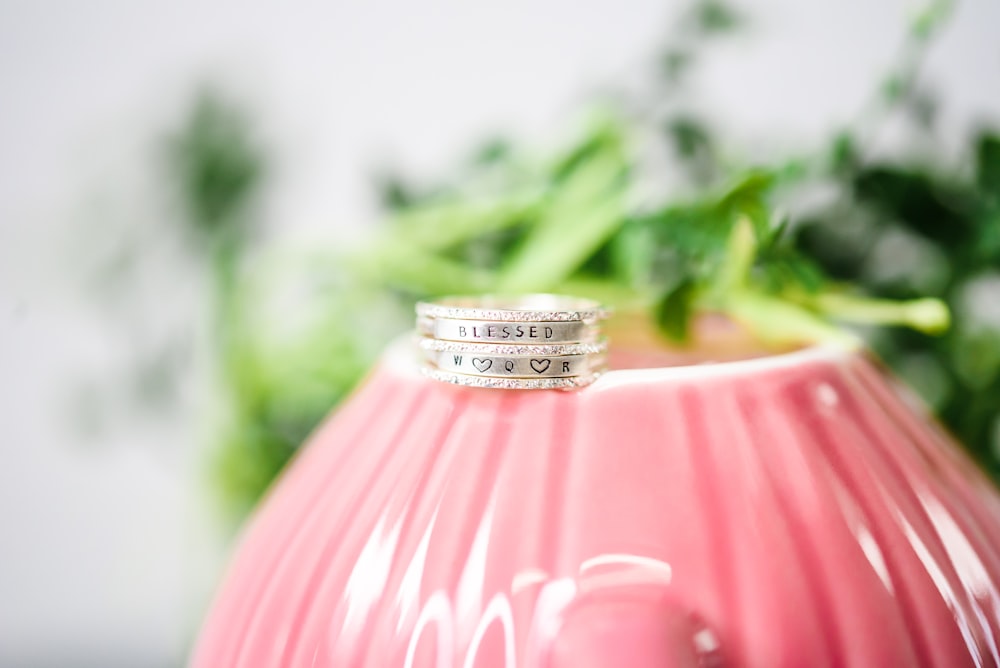 silver ring on pink lamp