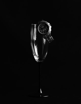 grayscale photo of a clear glass vase