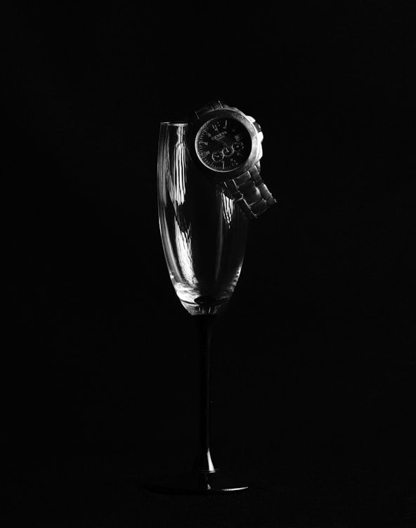 grayscale photo of a clear glass vase