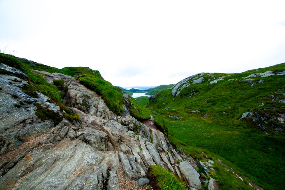 person walking on rocky mountain during daytime