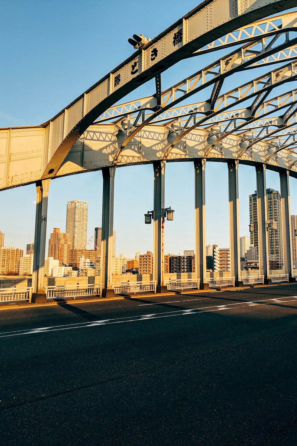 black metal bridge near city buildings during daytime