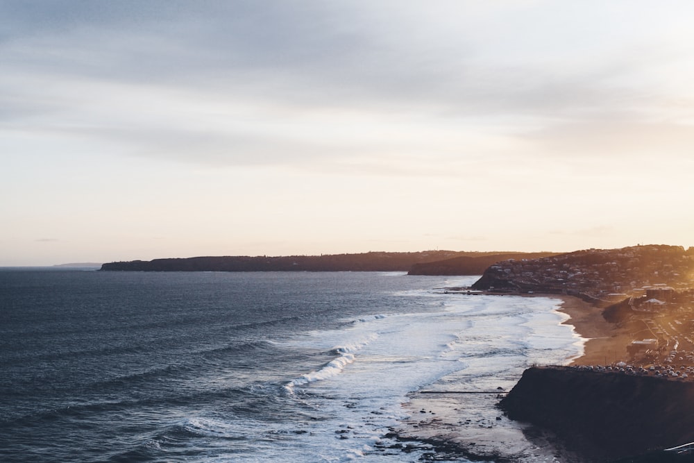 ocean waves crashing on shore during daytime