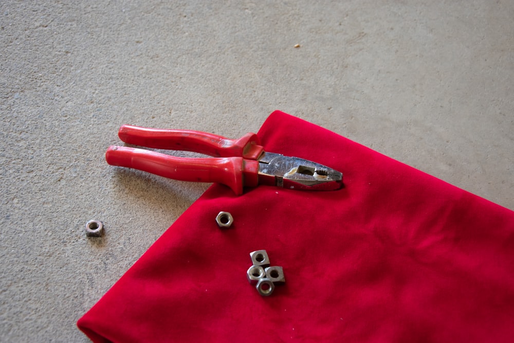 red and silver hand tool