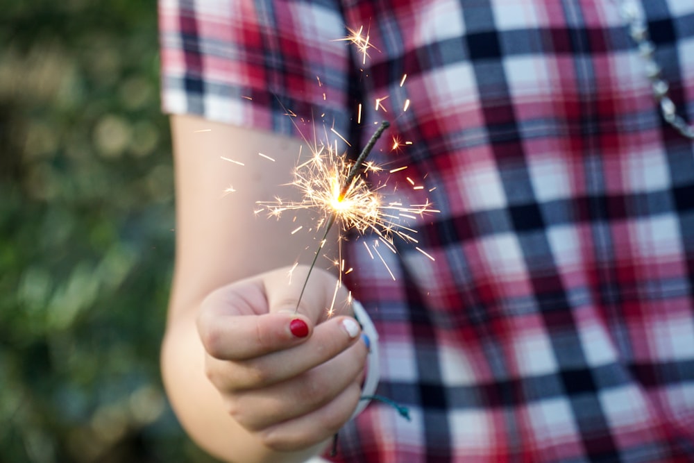 person holding yellow dandelion flower