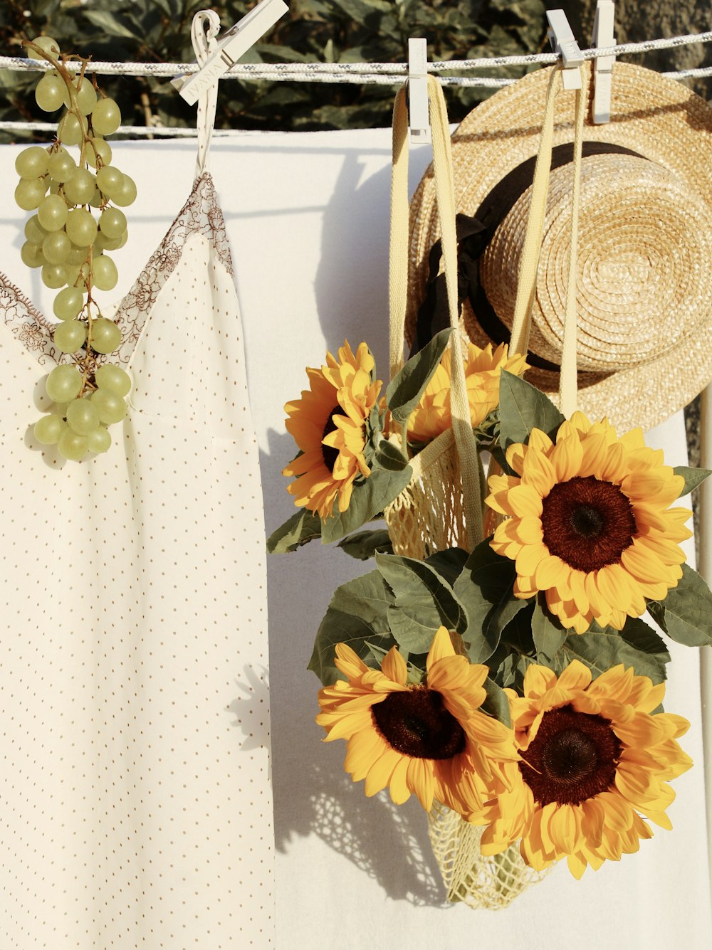 yellow sunflower bouquet beside brown straw hat