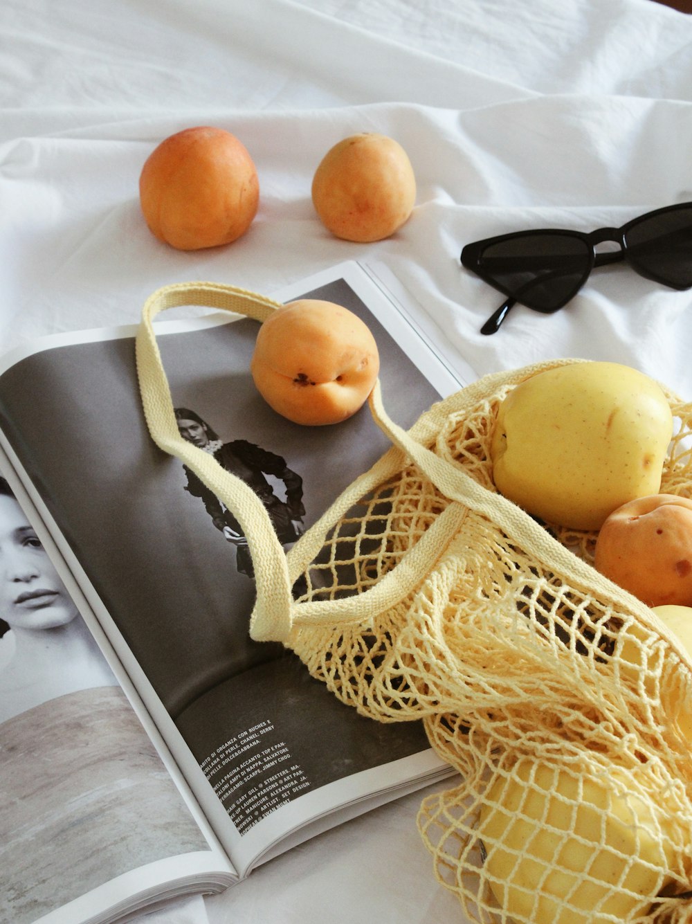 black sunglasses beside orange fruit
