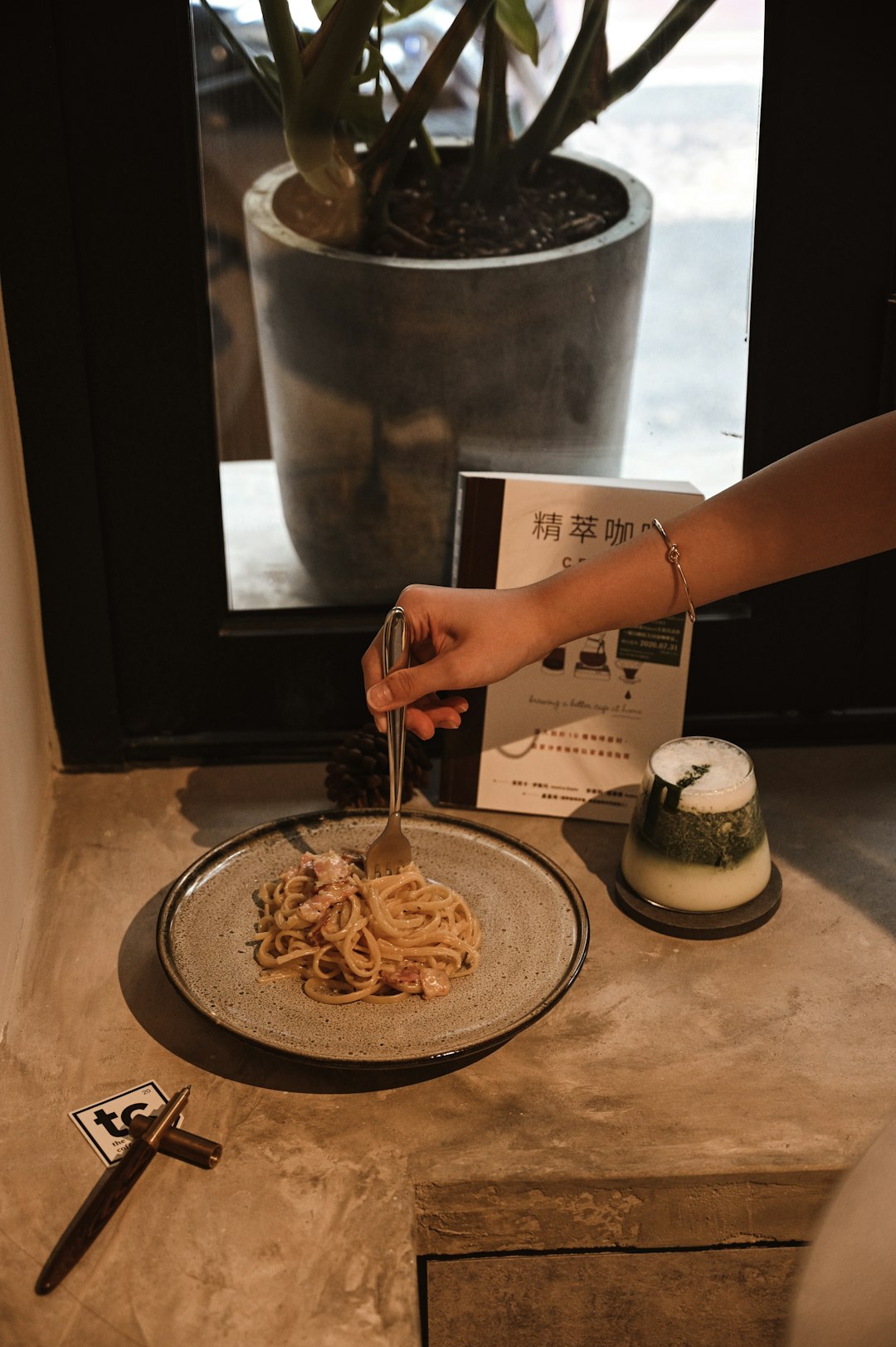 person holding fork and pasta