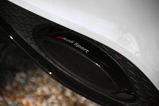 Close-up of colorful VW and Audi centre caps arranged on a sleek black surface.