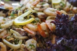 A colorful seafood salad with octopus, shrimp, and fresh vegetables.