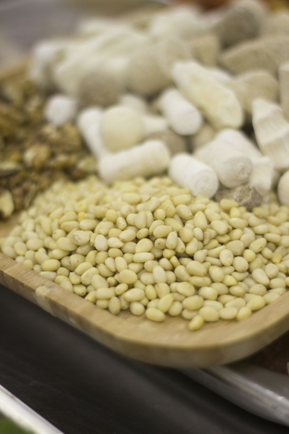 white and brown beans on brown wooden tray