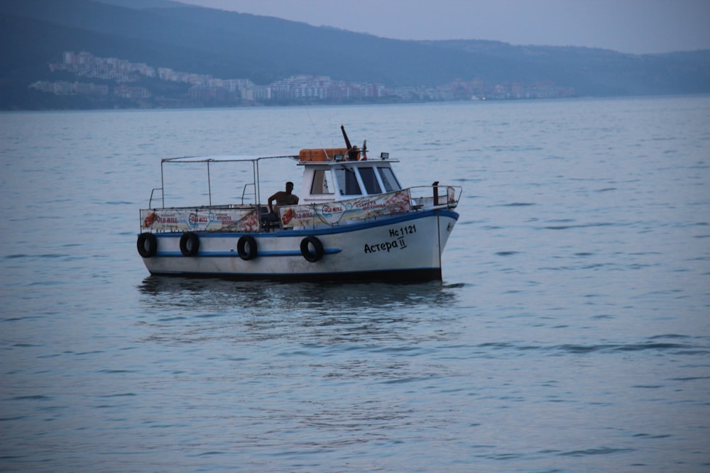 white and black boat on sea during daytime