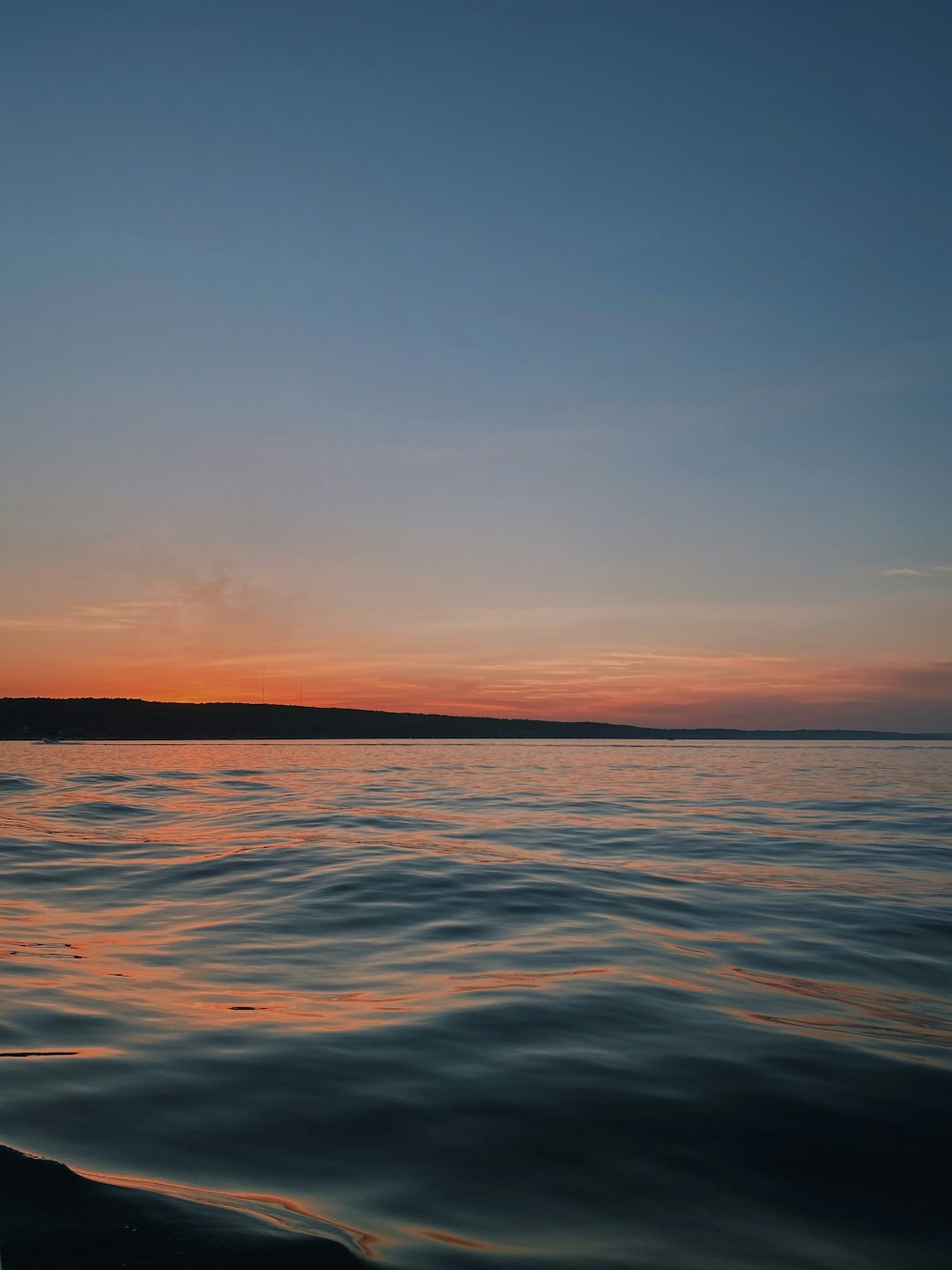 body of water during sunset