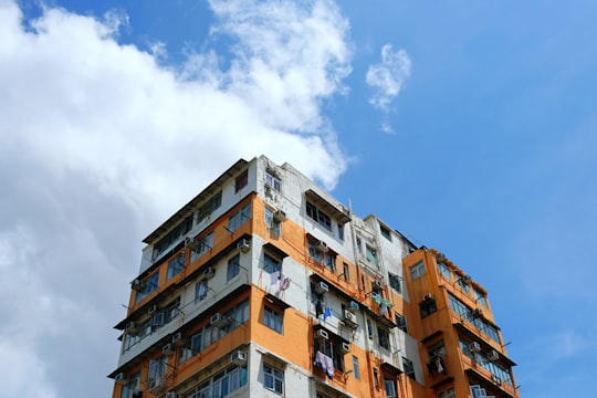 brown and white concrete building under blue sky during daytime in Sham Shui Po District Hong Kong