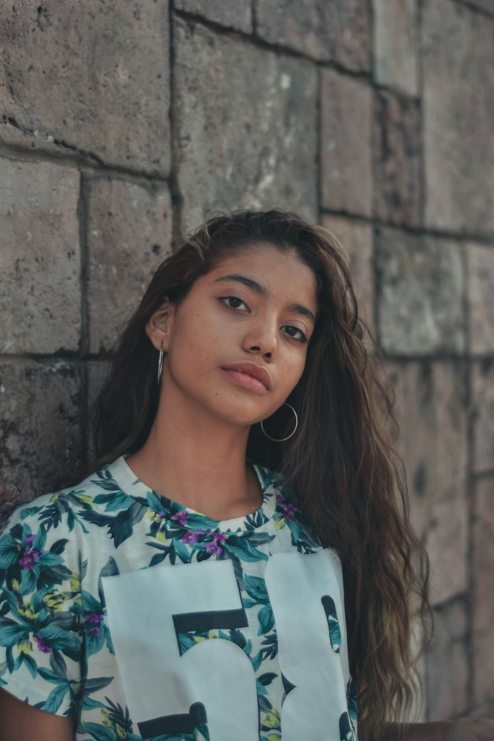 woman in white blue and green floral shirt