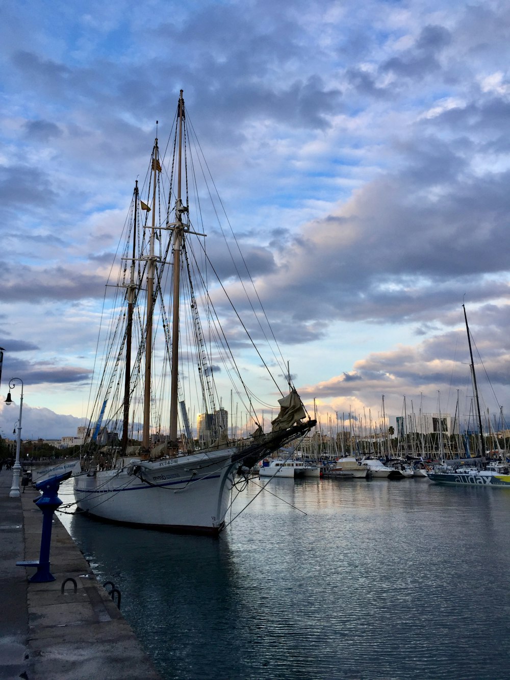 white sail boat on dock during daytime