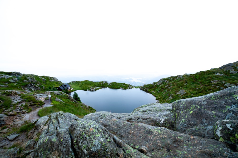 gray rocky mountain near body of water during daytime