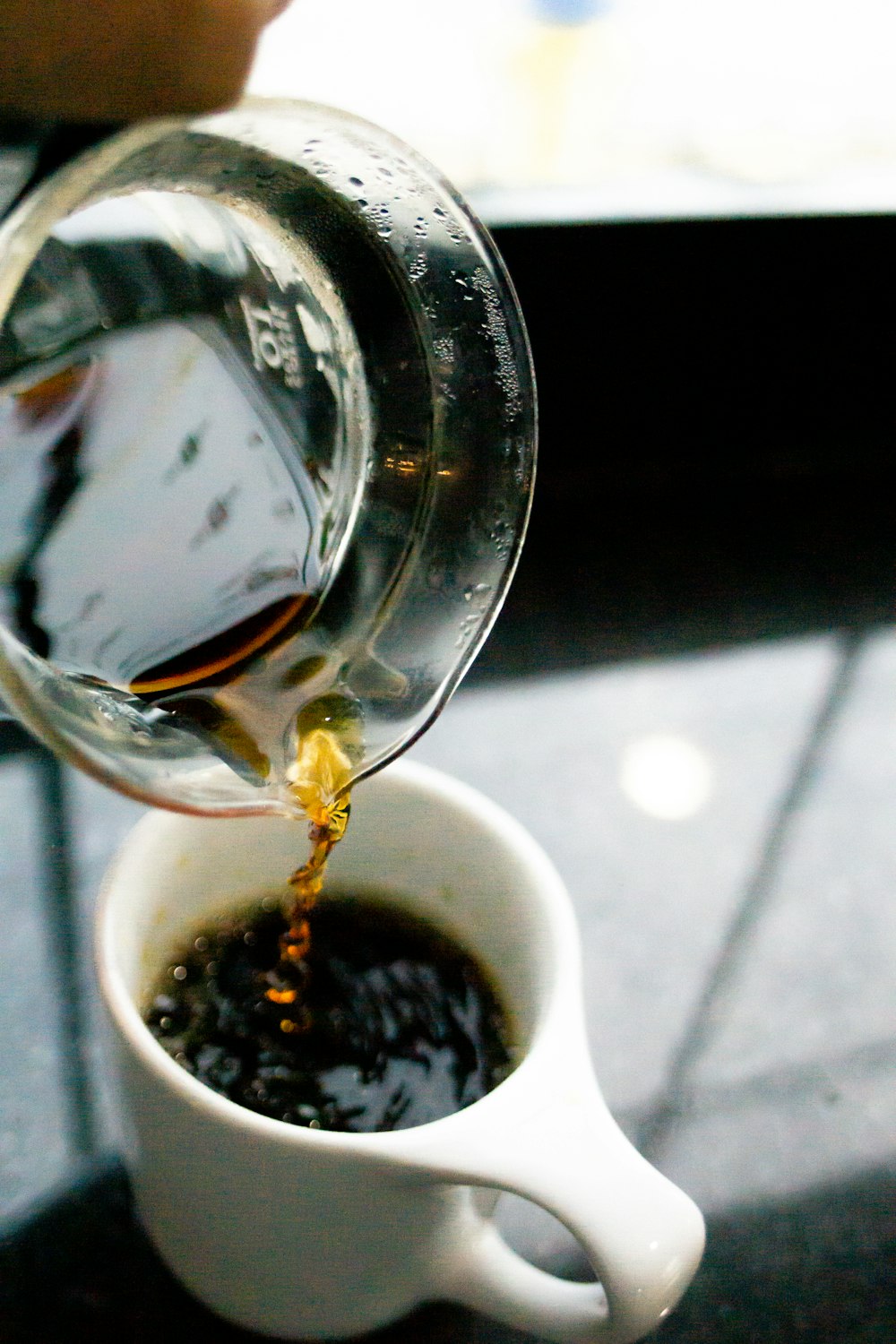 clear glass cup with black liquid