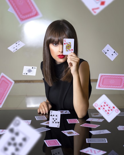 woman in black tank top holding white smartphone