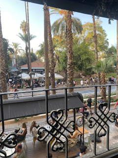 A cozy café terrace in Bucharest bustling with locals and visitors sipping coffee.