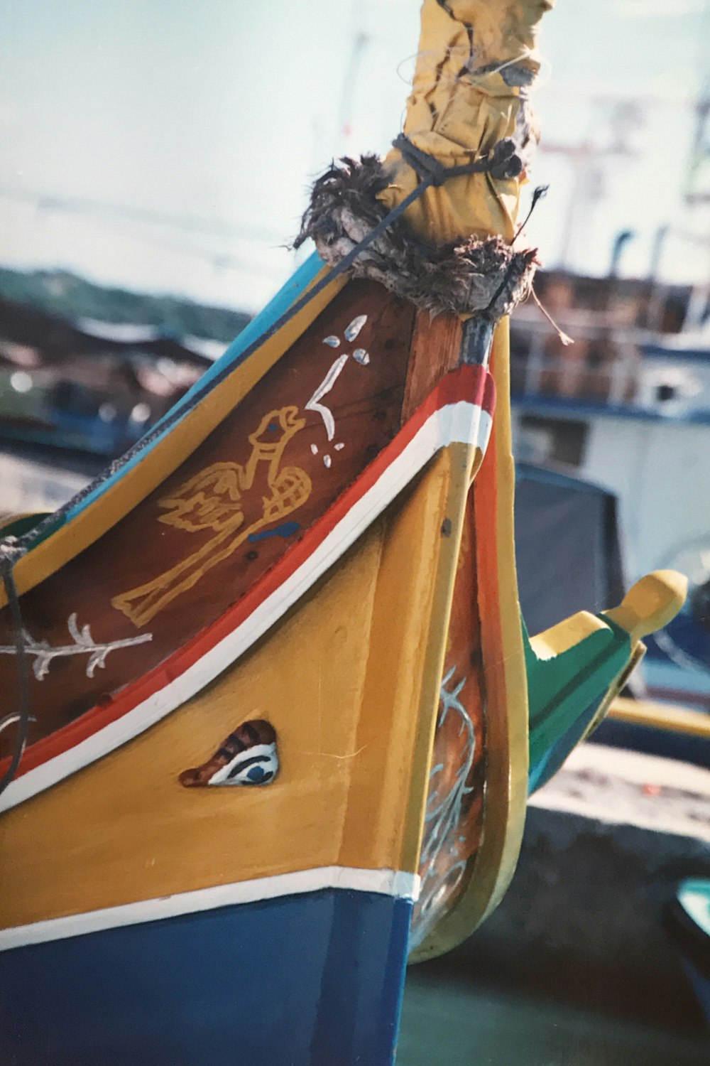 yellow red and blue boat on beach during daytime