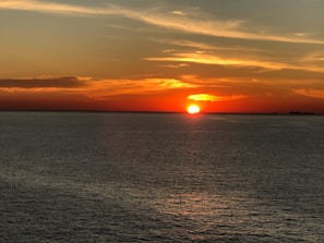 A vibrant sunset over a calm ocean.