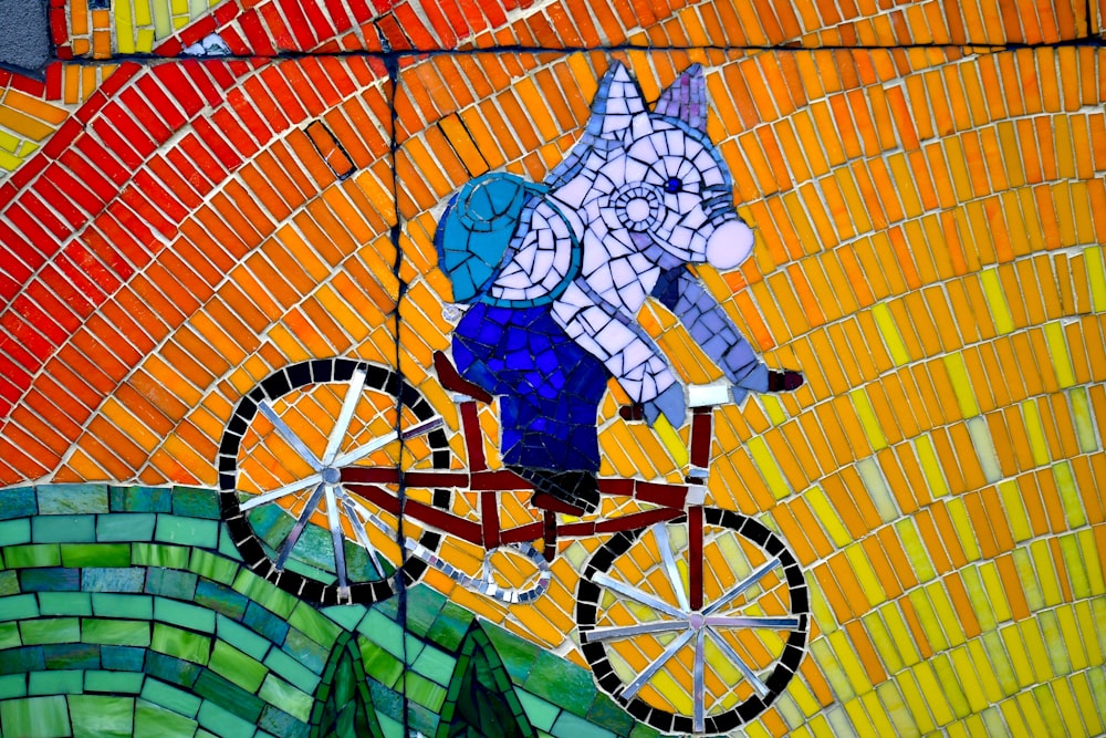 white and blue cat riding on bicycle wall art
