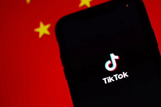 A dynamic smartphone screen showing a vibrant TikTok ad with high viewer engagement metrics.