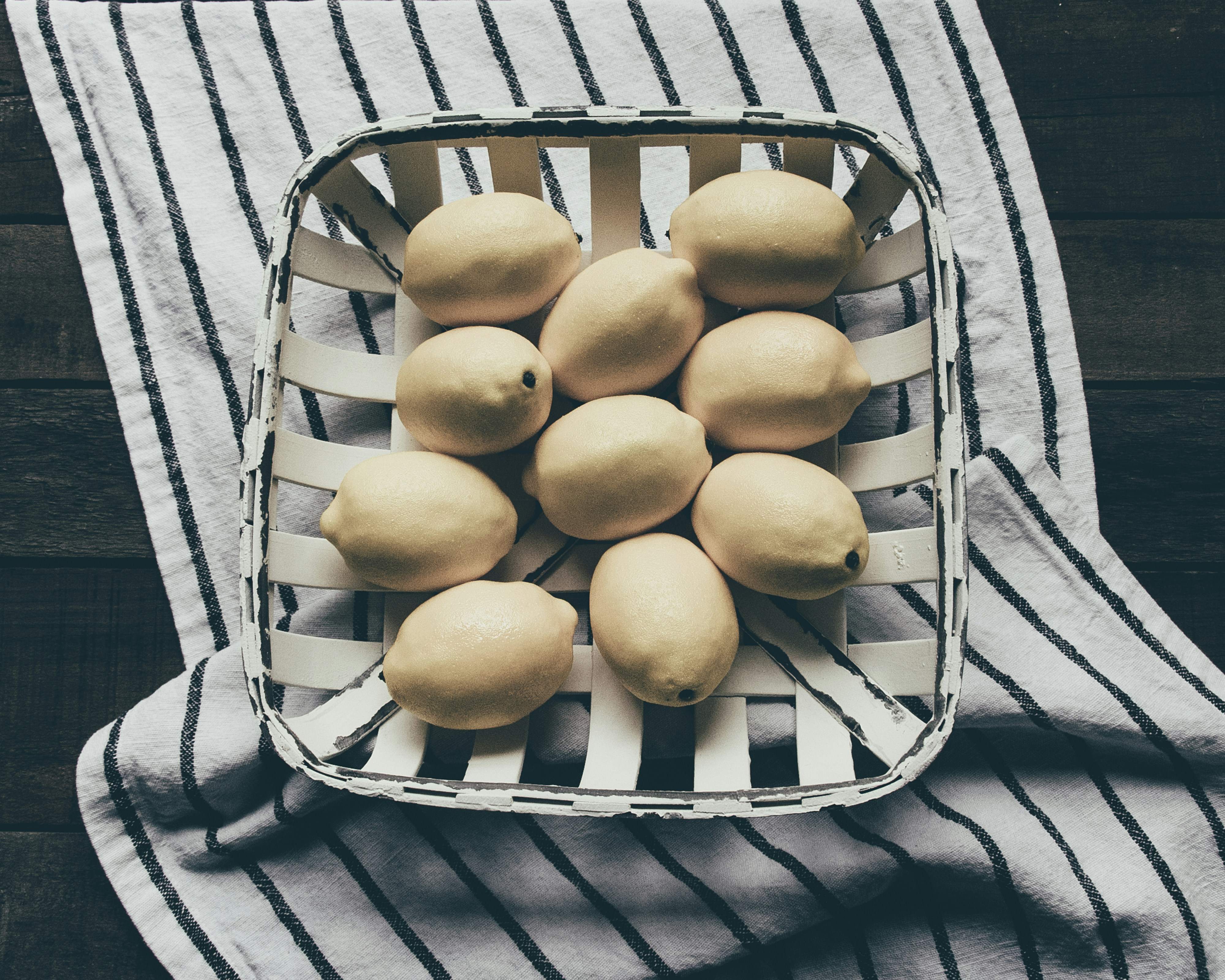 yellow oval fruits on gray metal rack