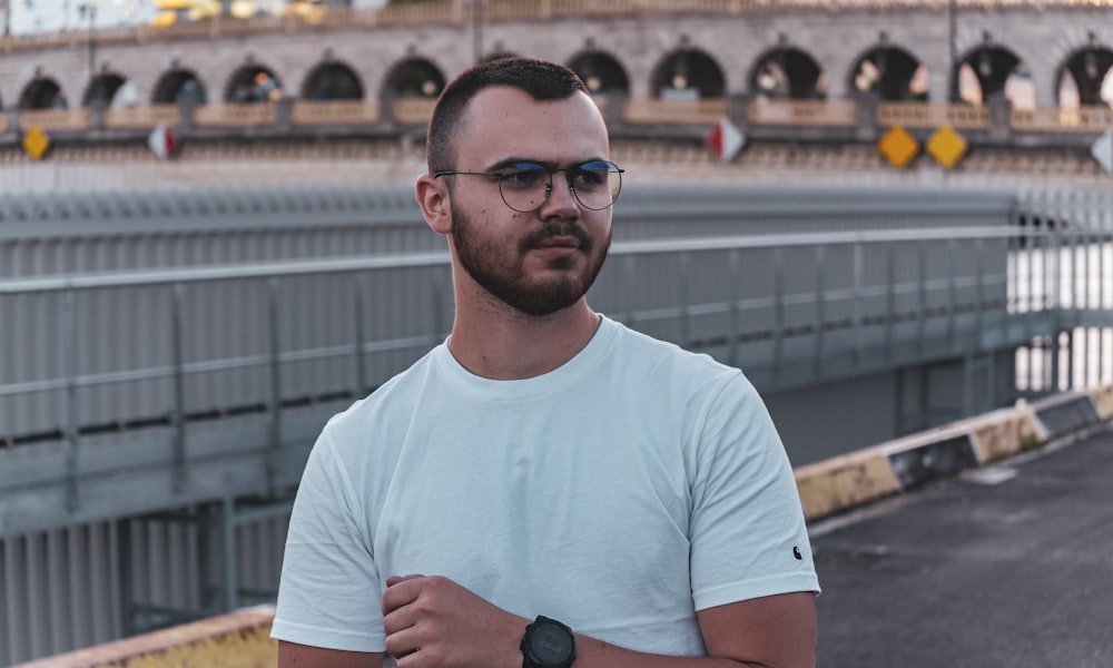 man in white crew neck t-shirt wearing black sunglasses