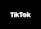 A minimalist logo featuring the word TikTok in a bold, white font centered on a black background. The 'o' in TikTok is stylized with a design resembling a musical note, incorporating subtle blue and red hues.