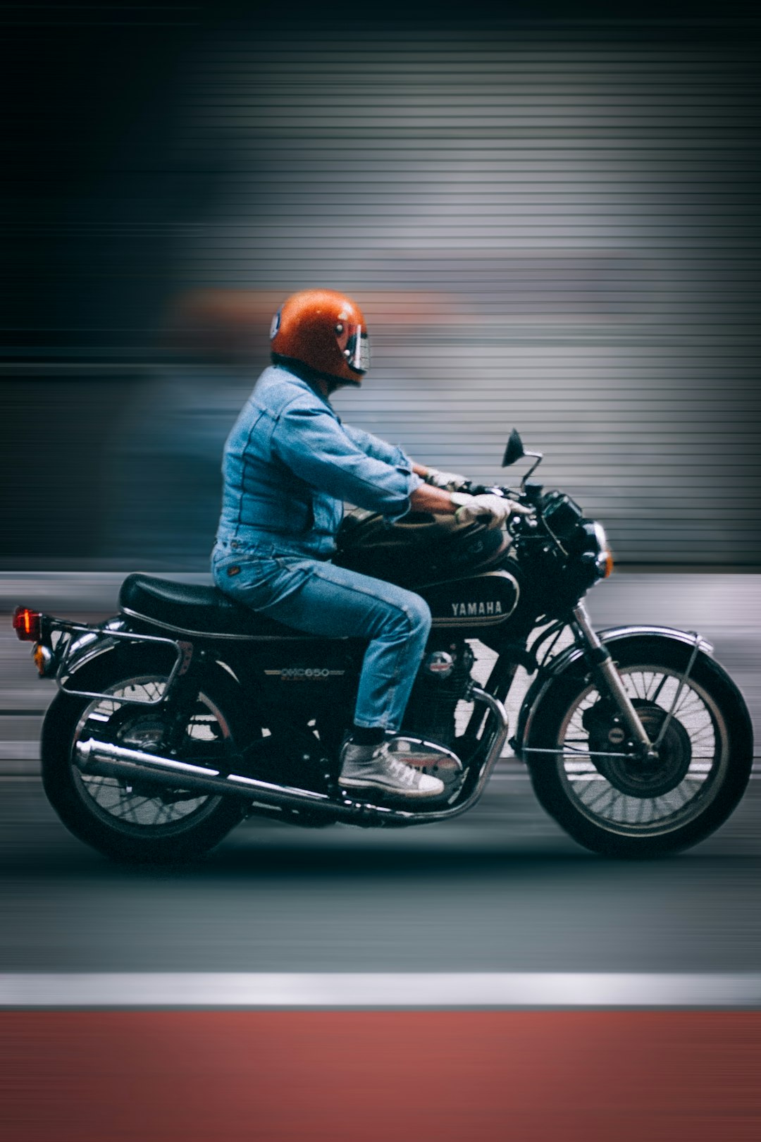man in blue jacket riding black motorcycle