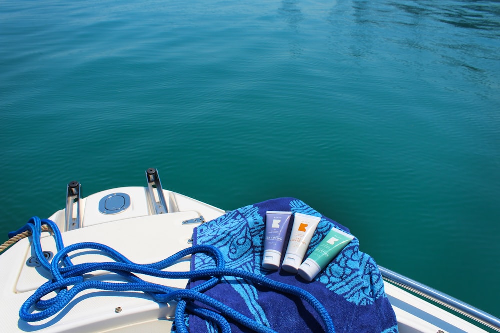 blue and white textile on white boat