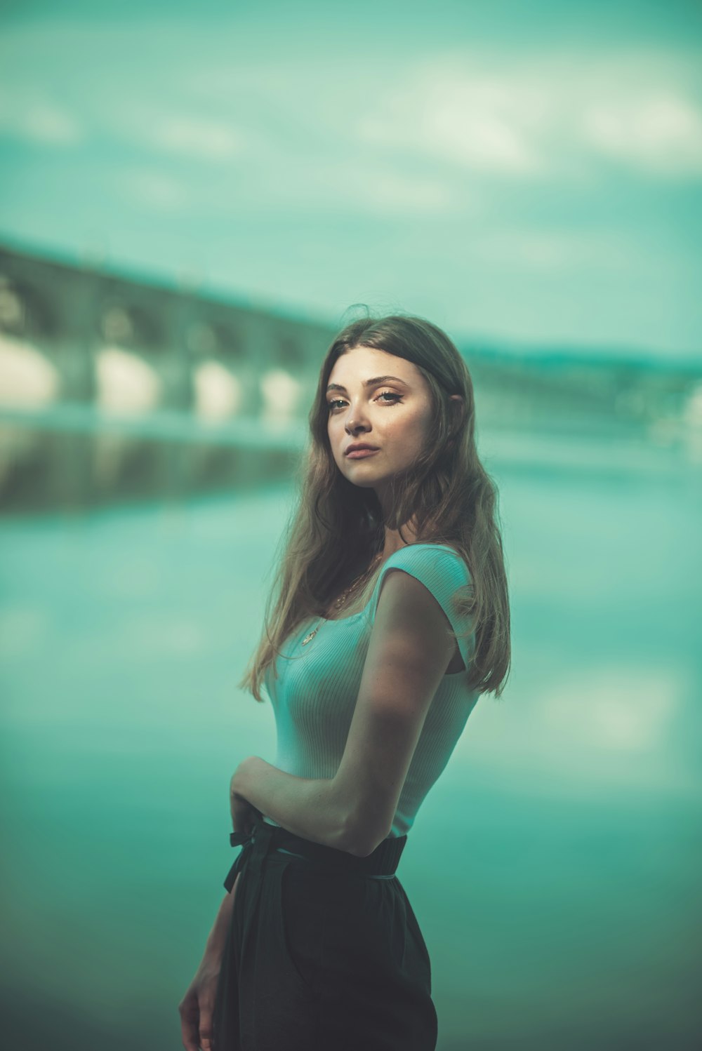 woman in green tank top and black pants