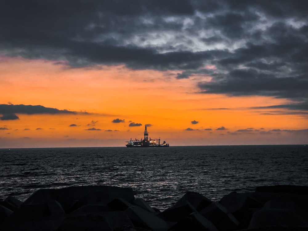 silhouette of people on sea during sunset