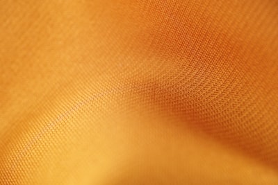 brown textile in close up photography textile teams background