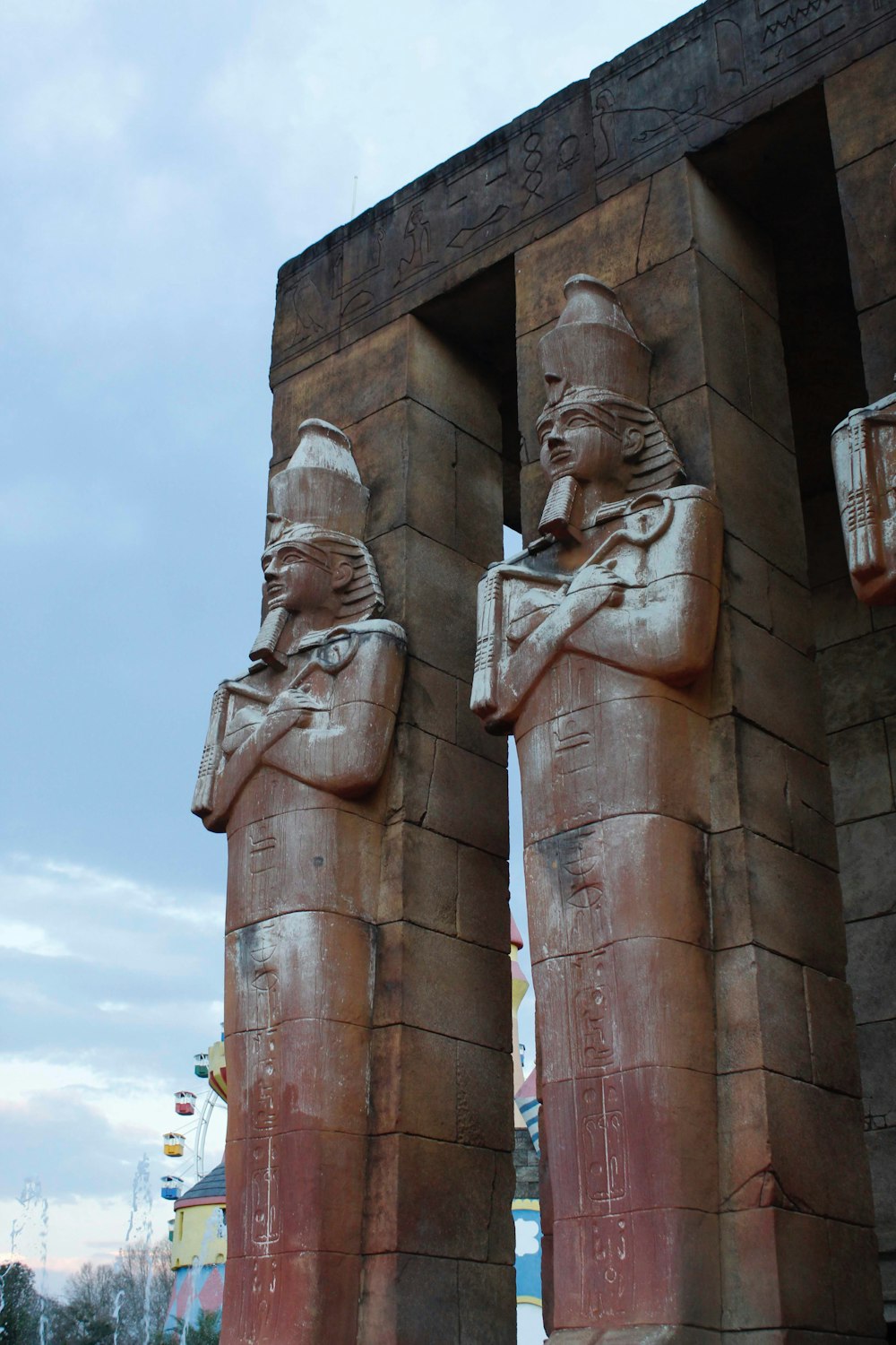 brown concrete statue under blue sky during daytime