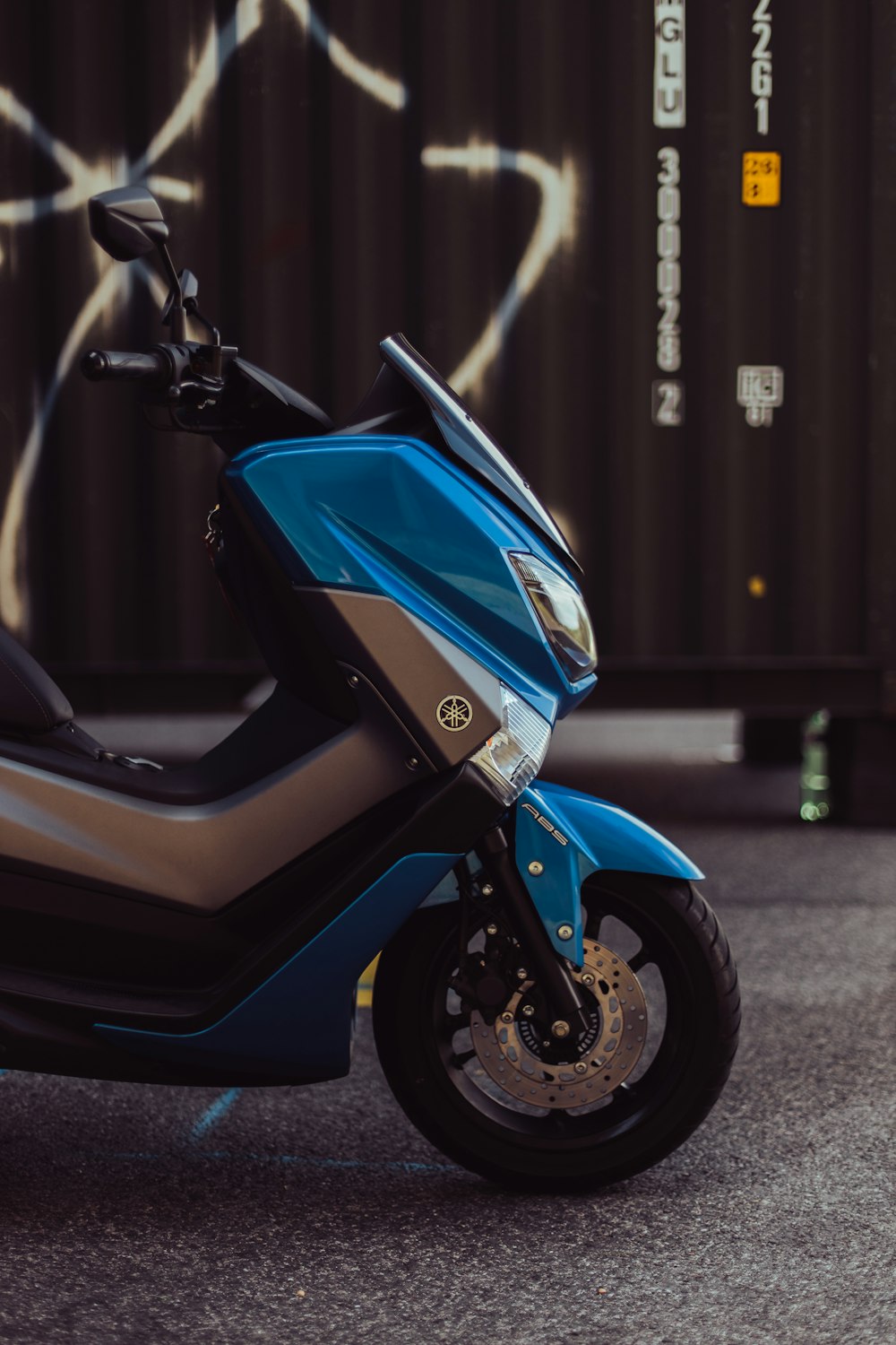 blue and black motorcycle on gray concrete road during daytime